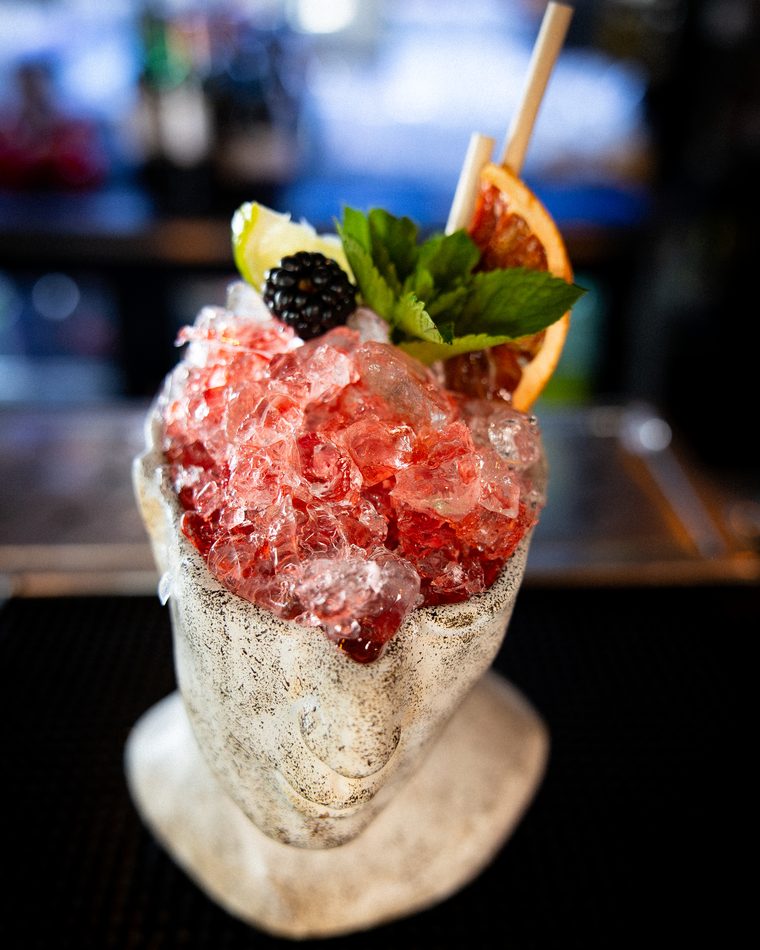A cocktail with crushed ice and fresh berries at Spark Bar & Kitchen