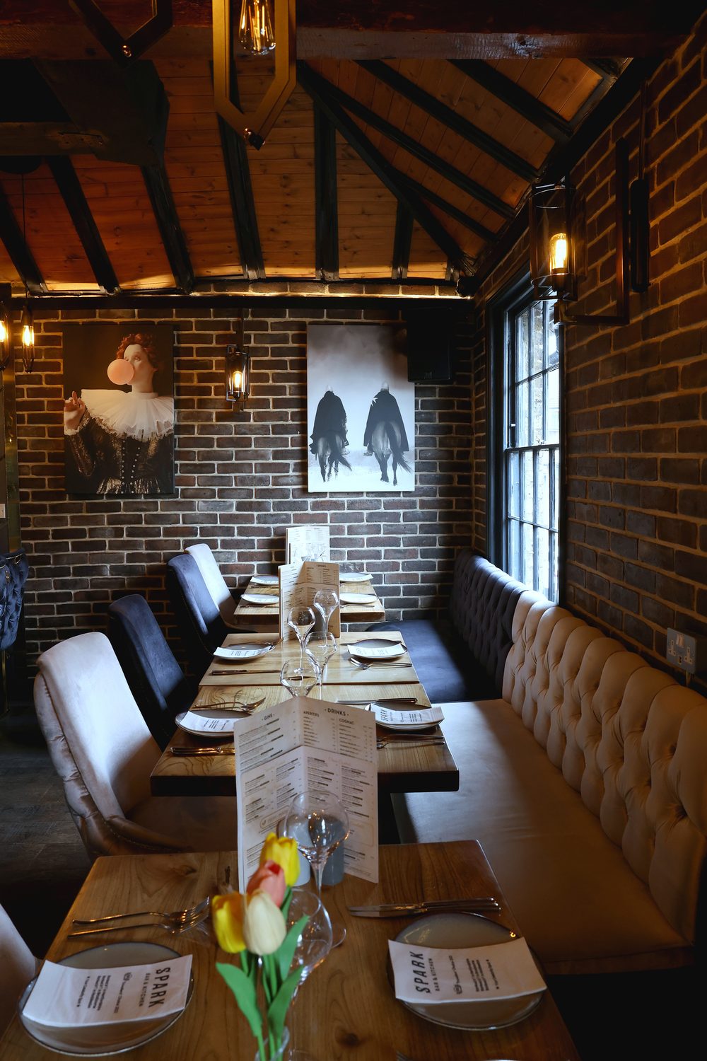 A table set with menus in the dining room at Spark Bar & Kitchen
